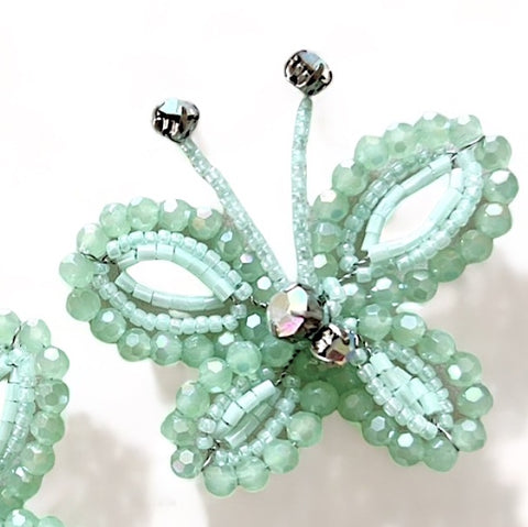 Buy the most adorable childs butterfly clip set in mint green.  Each butterfly is handcrafted with soft pastel mint green cut crystal beads with rainbow rhinestones by Sienna Likes to Party