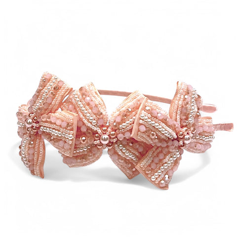 Best kids luxury handcrafted hair accessories by Sienna Likes to Party.  The Jolie bow headband is hand-beaded with apricot crystals and pearls on a satin bow headband.  Perfect for flower girls and kids special occasions