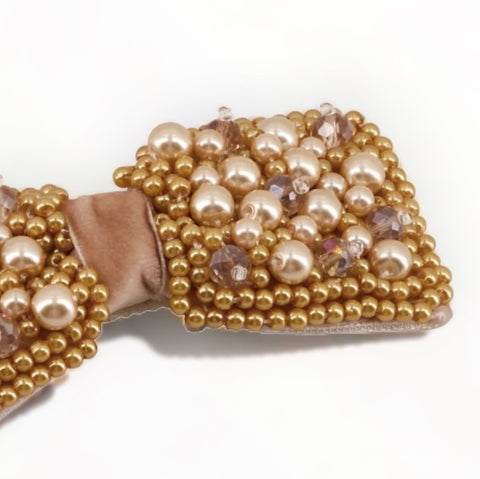 Buy the best luxury kids gold hair bow clip.  This designer kids accessory is entirely handmade with gold pearls, blush crystals and set on a superior quality beige velvet bow.