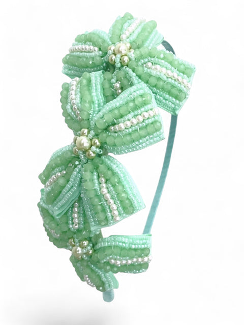 Best luxury hand beaded girls bow headband.   The Jolie hair adornment is uniquely handmade with mint green beads and pearls, perfect bespoke luxury for the mini princess.