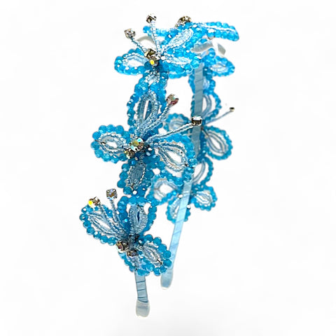 Buy the best luxury blue butterfly headband for children, handmade with blue crystals and rainbow diamantes.  A cute hair accessory by Sienna Likes to Party Brand