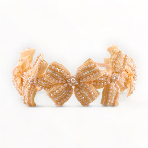 Best designer toddler bow hairbands in apricot.  Luxuriously hand beaded with cut crystals and pearls.  Designed by Sienna Likes to Party, fashion accessories for kids