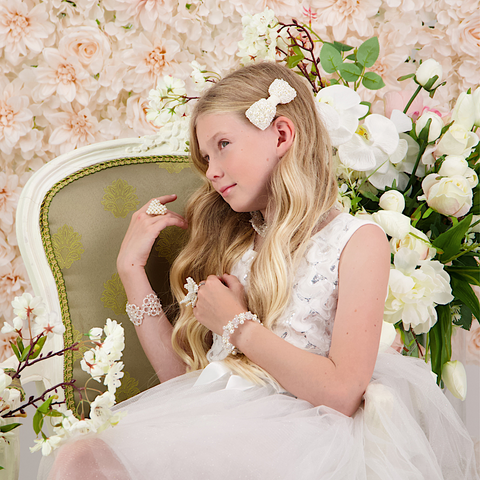 Luxury White hair hair bow for girls, highly embellished with ivory pearls and clear crystals, on a white velvet childs bow.