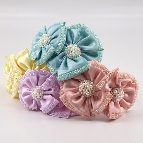 Luxury pastel coloured hair accessories for children by sienna Likes to Party.  Each piece is uniquely handmade with hundreds of  hand stitched crystals and pearls to create the perfect sparkle for childrens special occasion parties